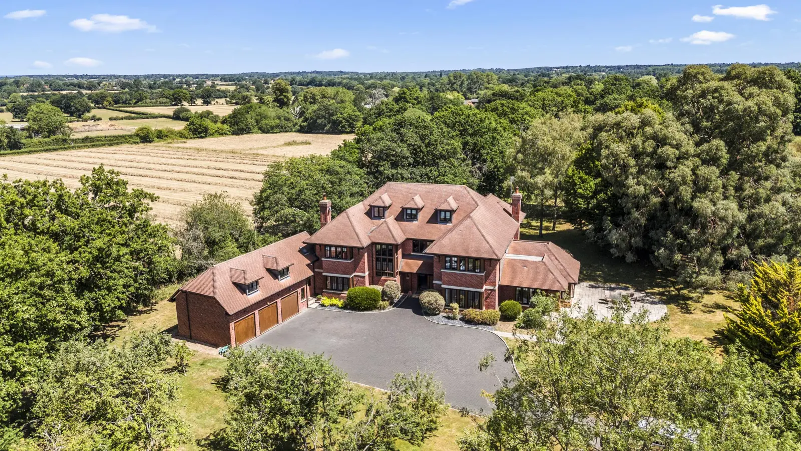 Drone photography of a detached house in Berkshire with gardens, driveway and open countryside