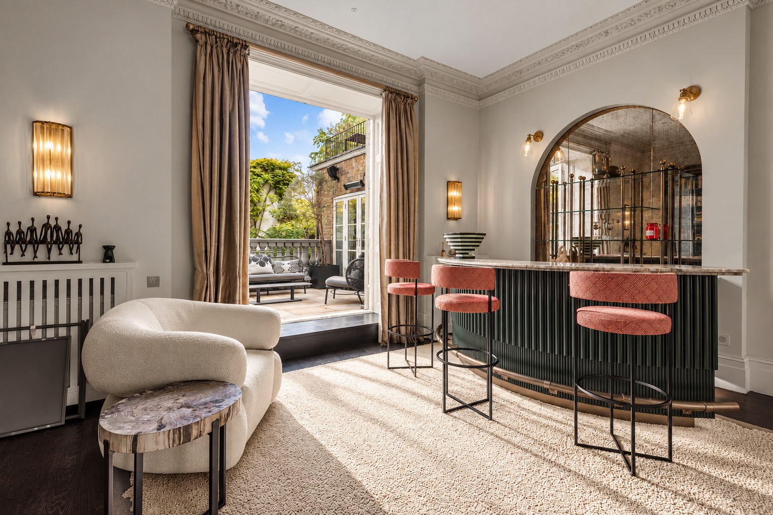 Property photography in a Kensington townhouse: lounge with arched bar, pink velvet stools and terrace doors