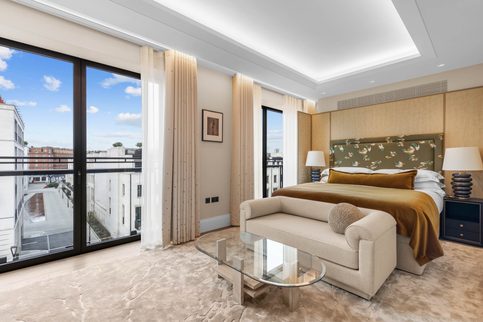 Bedroom photography in a Knightsbridge apartment: floor-to-ceiling windows, silk headboard and city views