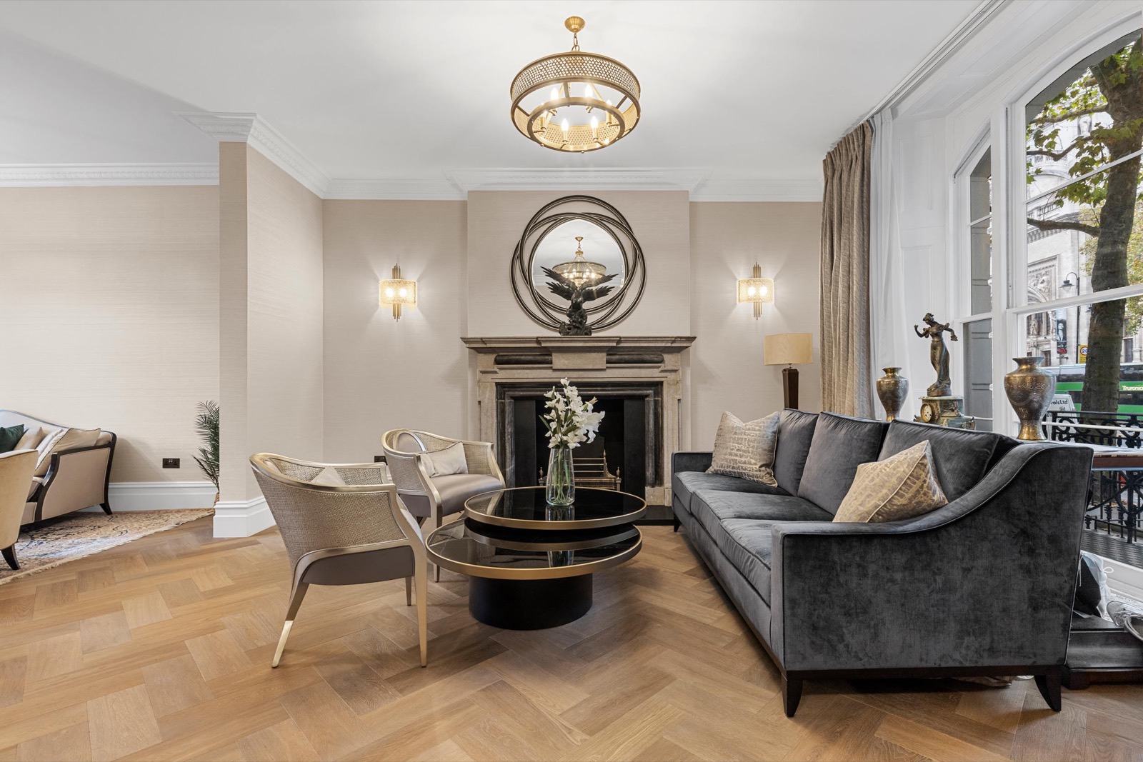 Living room photography in a Kensington townhouse: marble fireplace, velvet sofa and herringbone floor