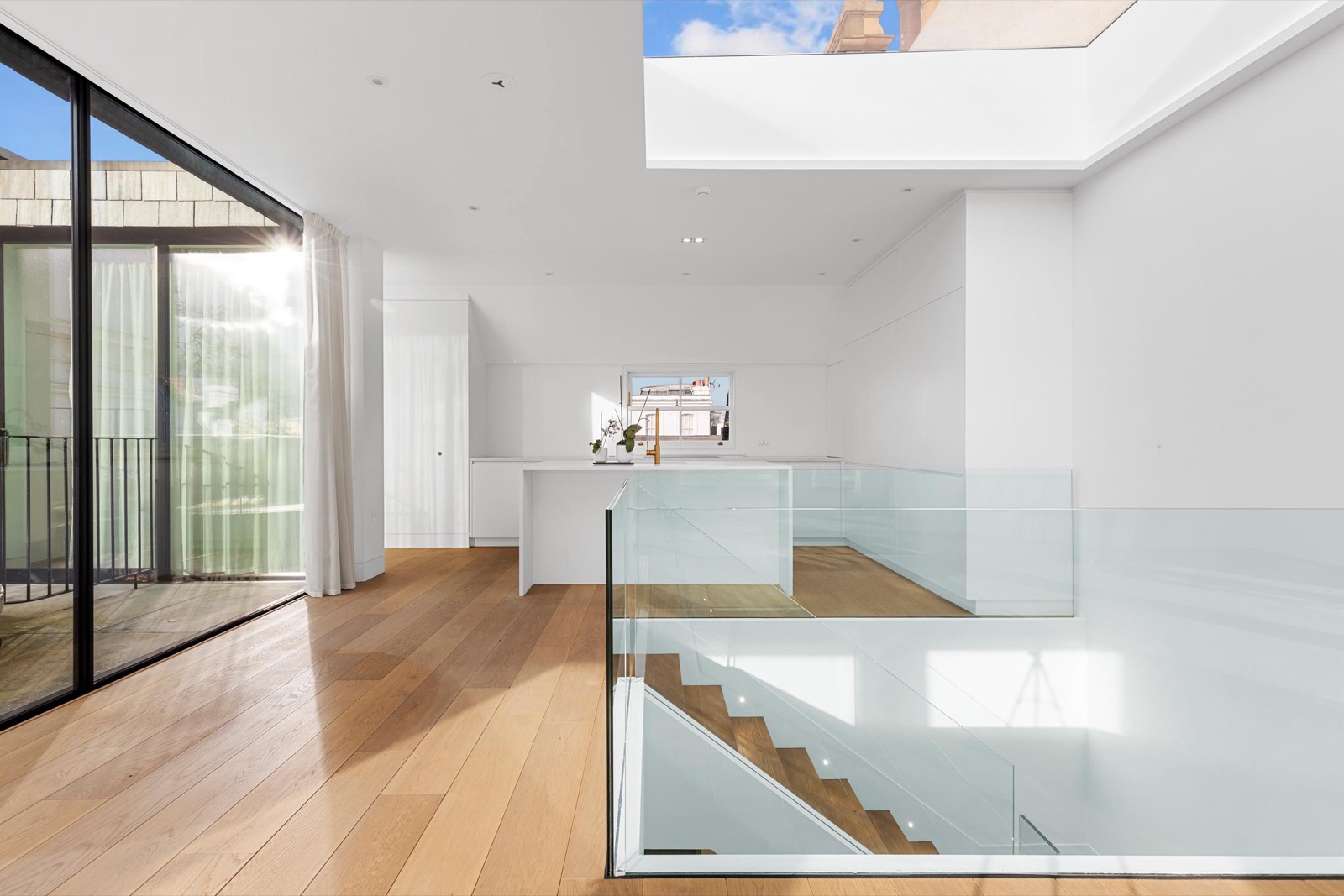 New-build property photography in Marylebone: glass balustrade staircase, oak floor and full-height glazing