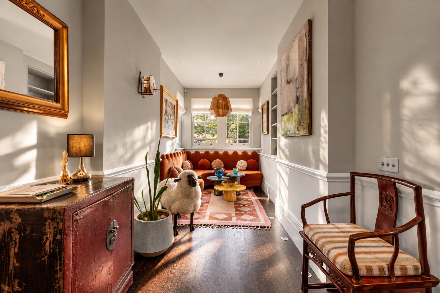 Property photography in Chelsea: characterful sitting room with lacquered chest, antique chairs and sunlit windows