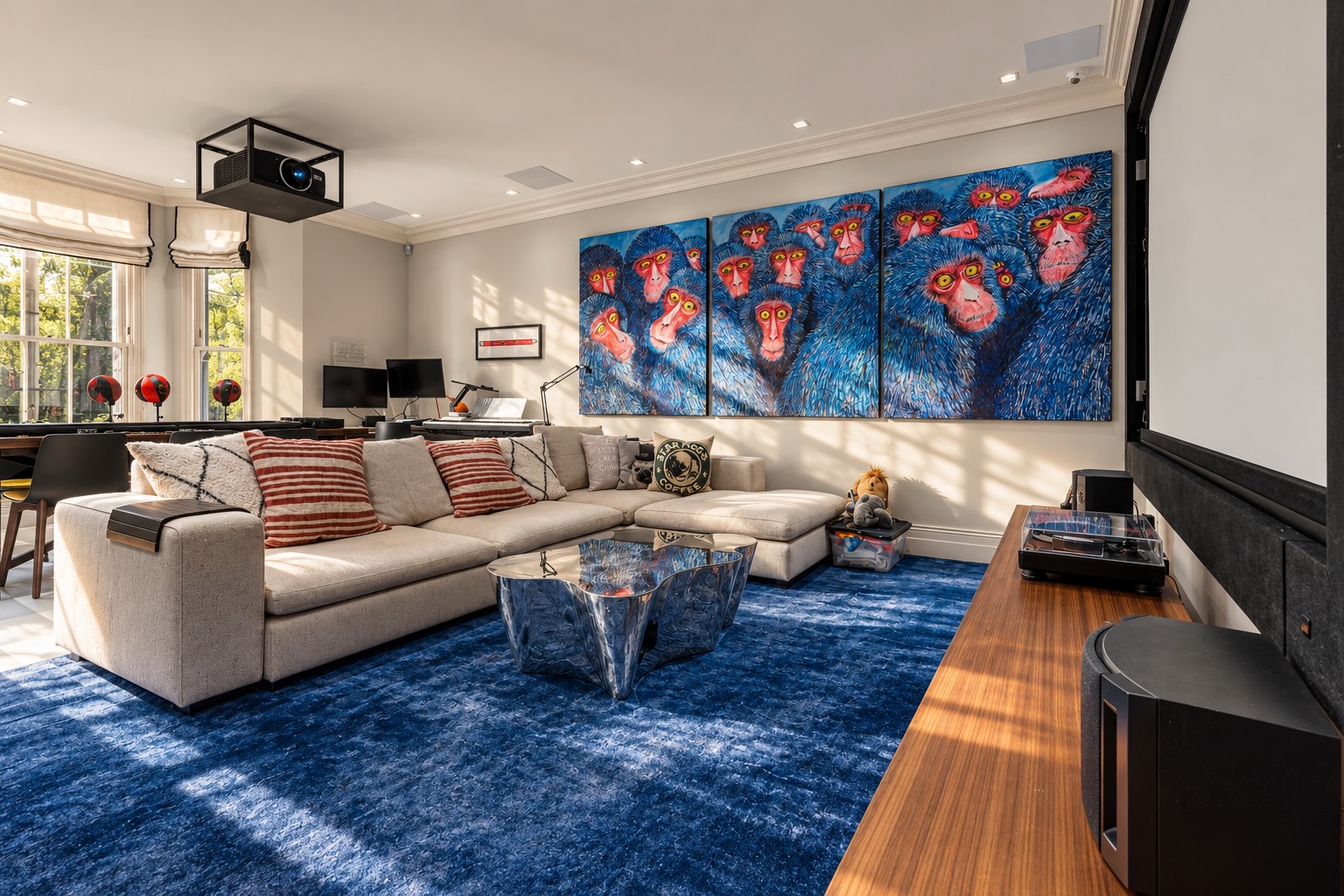 Media room photography in a Holland Park house: deep blue rug, L-shaped sofa and large artwork