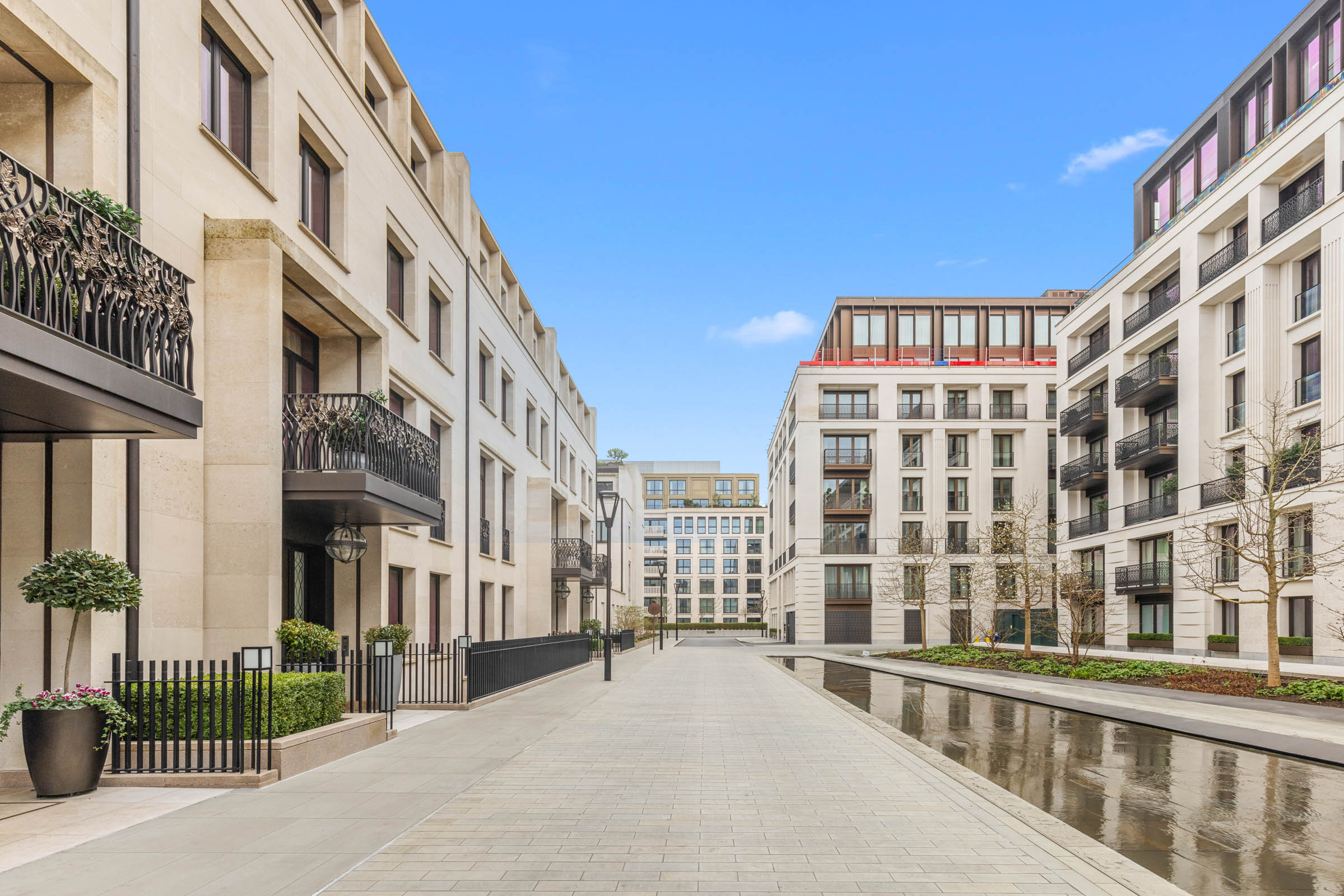 New development photography in Chelsea: limestone mansion blocks and a reflecting pool, shot for an estate agent
