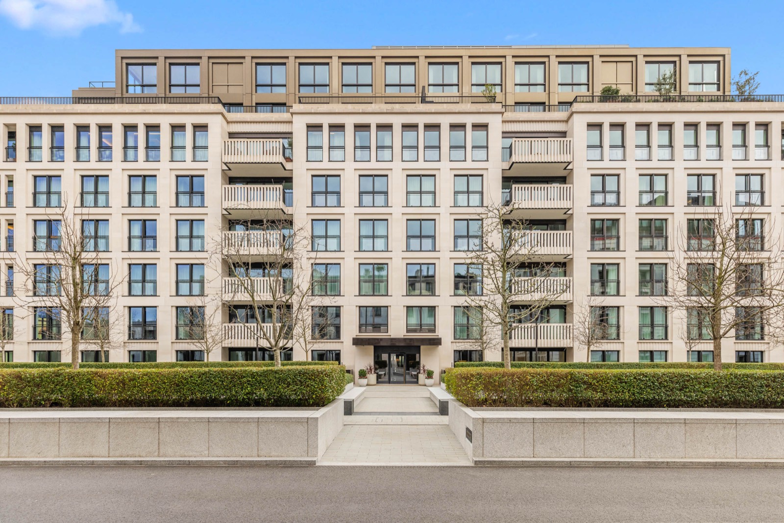 New development photography in St John's Wood: stone-clad apartment building with landscaped entrance