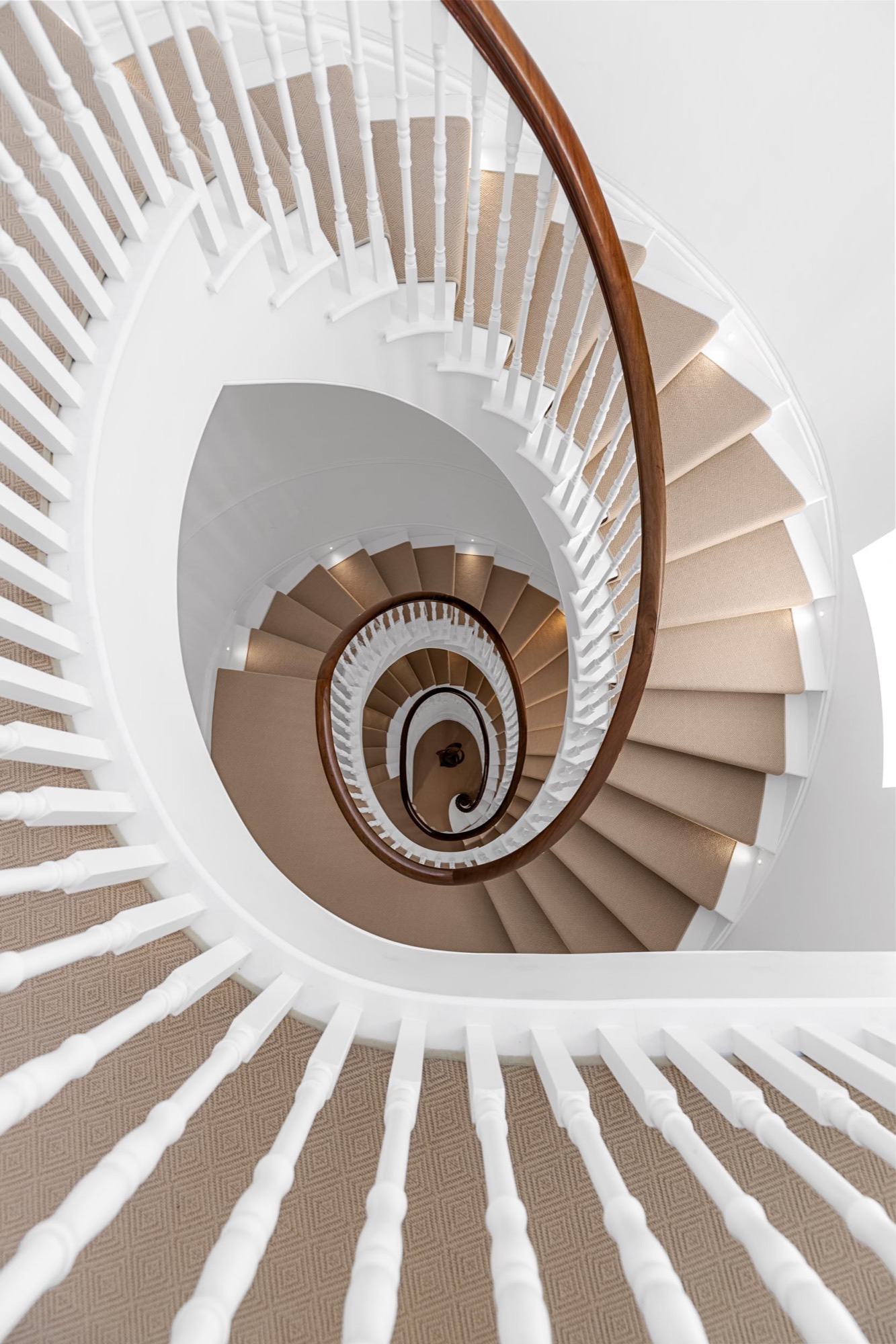 Spiral staircase photographed from above in a Belgravia townhouse